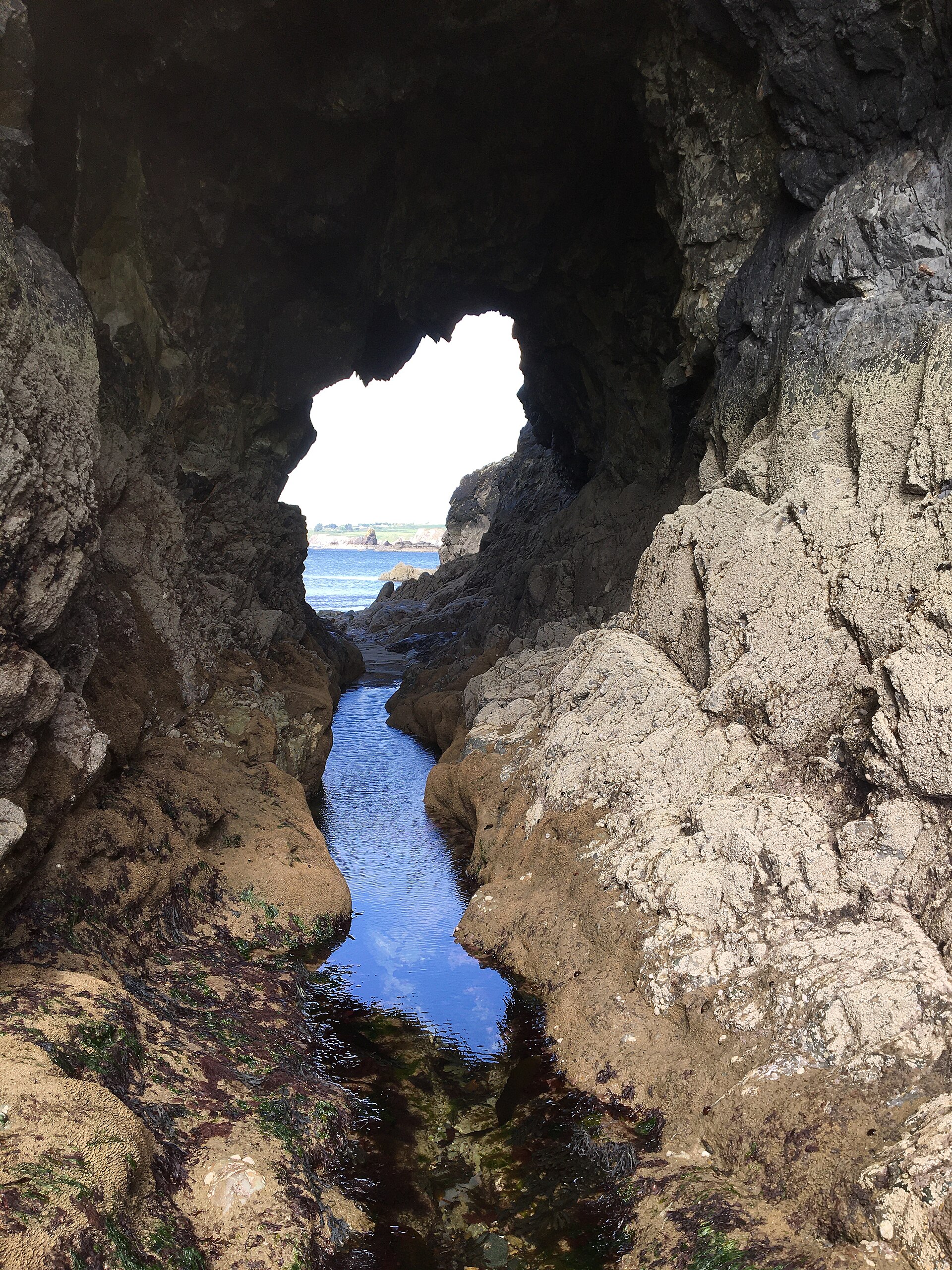 Natural sea arch cut into the rock on the Copper Coast, Co. Waterford