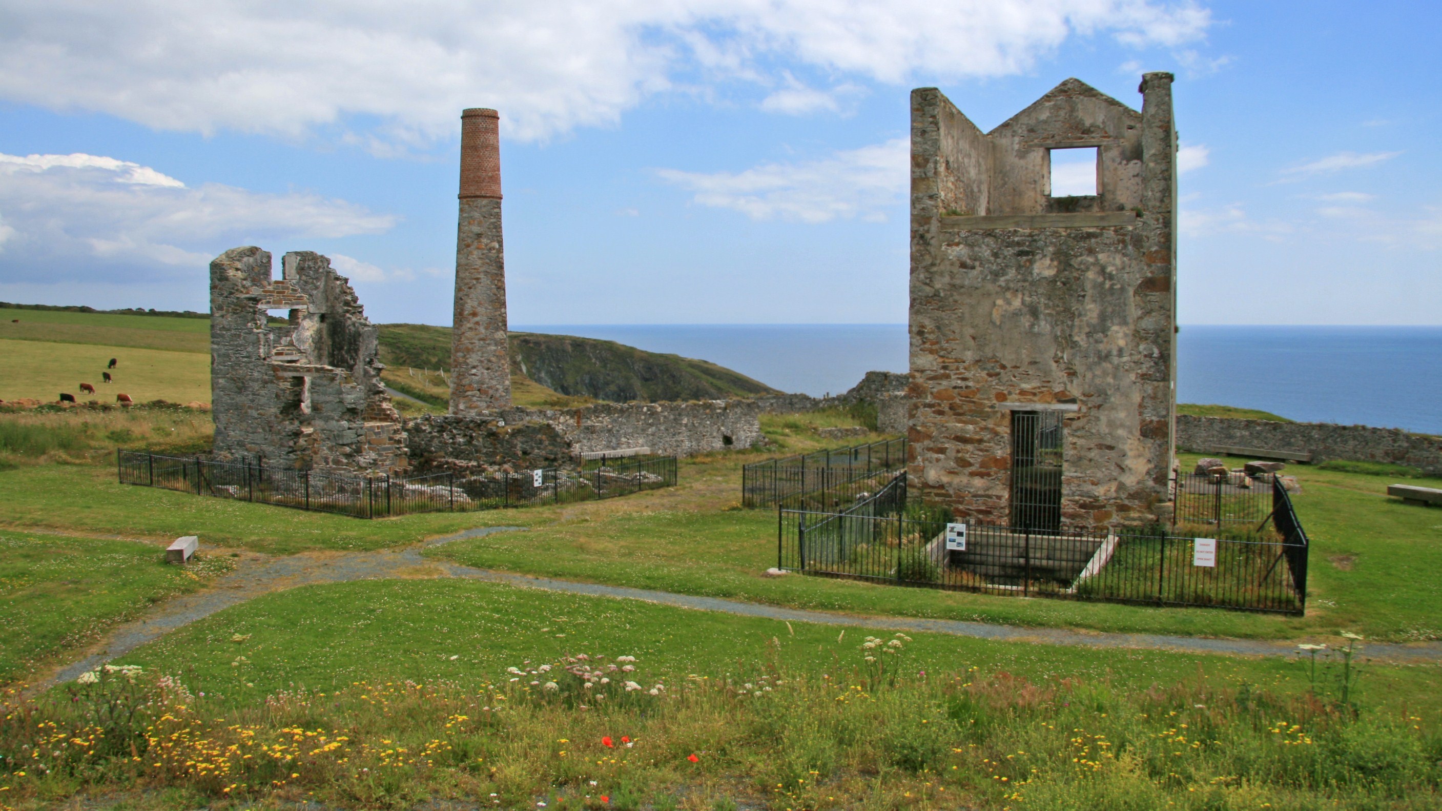 The Cornish engine houses at Tankardstown copper mine standing above the sea at Bunmahon